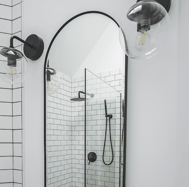 bathroom mirror leaned against white wall