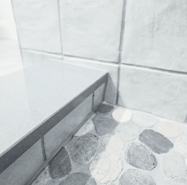 white bathroom tiles with stone detailing
