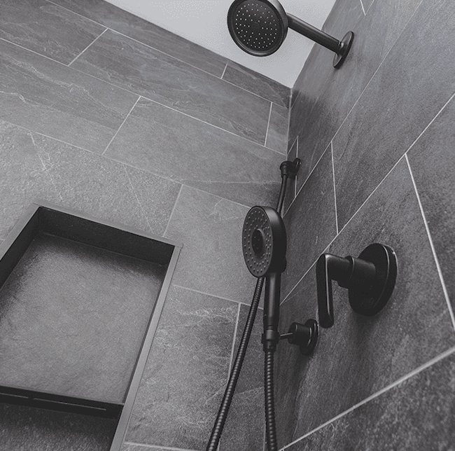 matte black showerhead on dark gray tiles
