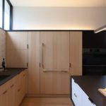 kitchen cabinets with natural ash finish & black stained countertop