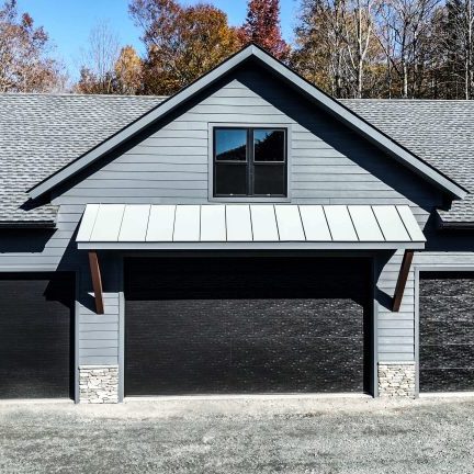 New Garage Construction with Hardie siding and a standing seam metal roof.