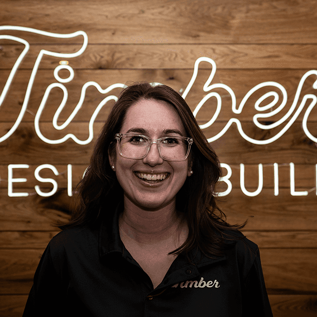 amanda2 Amanda Barton, interior designer at Timber Design + Build, smiling in a professional setting.