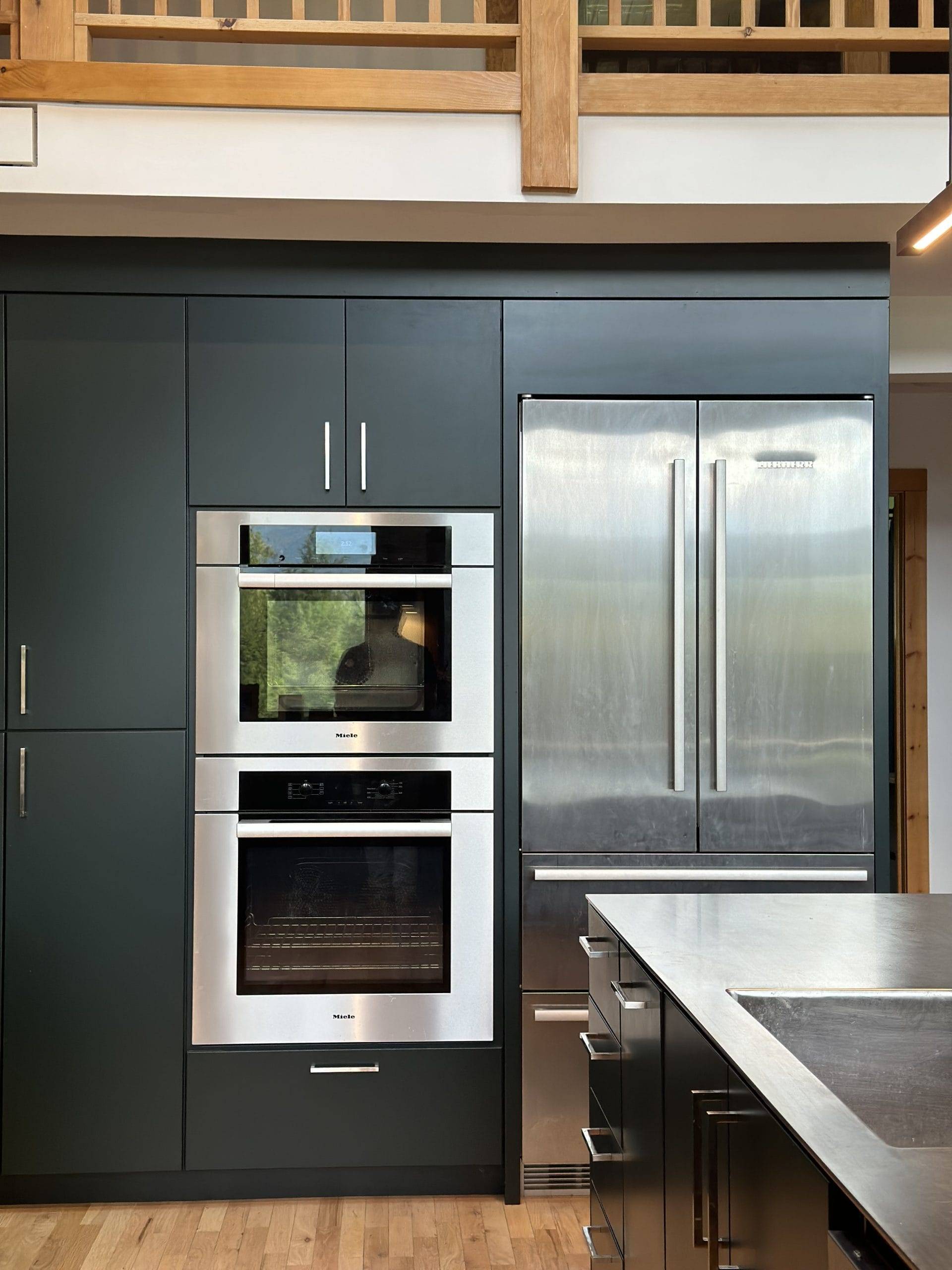 dark green kitchen oven and refrigerator
