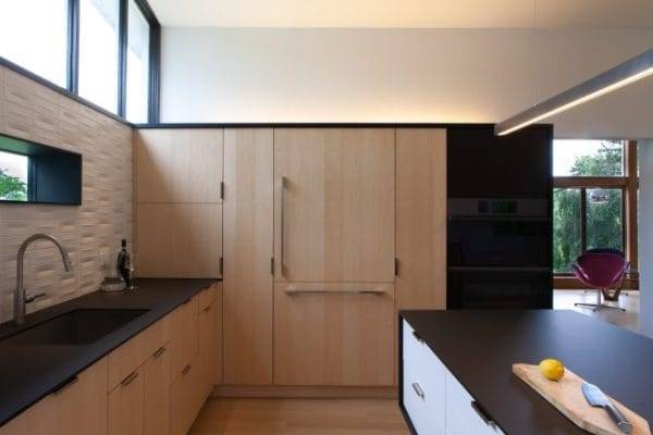 kitchen cabinets with natural ash finish & black stained countertop